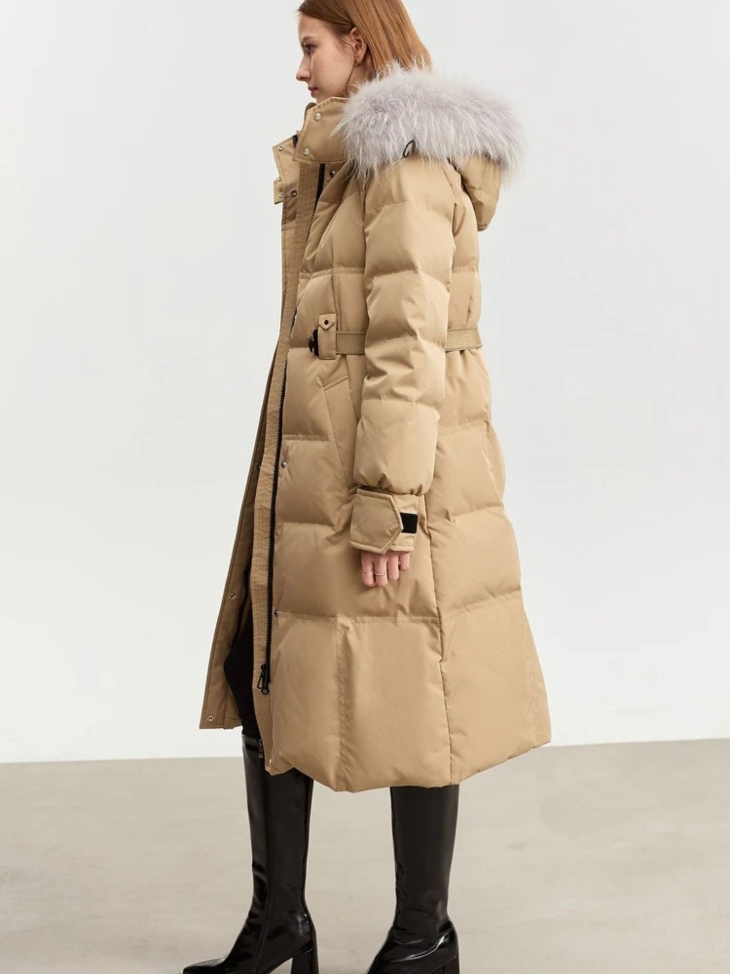 Side view of the beige coat, showing the full length and relaxed fit
