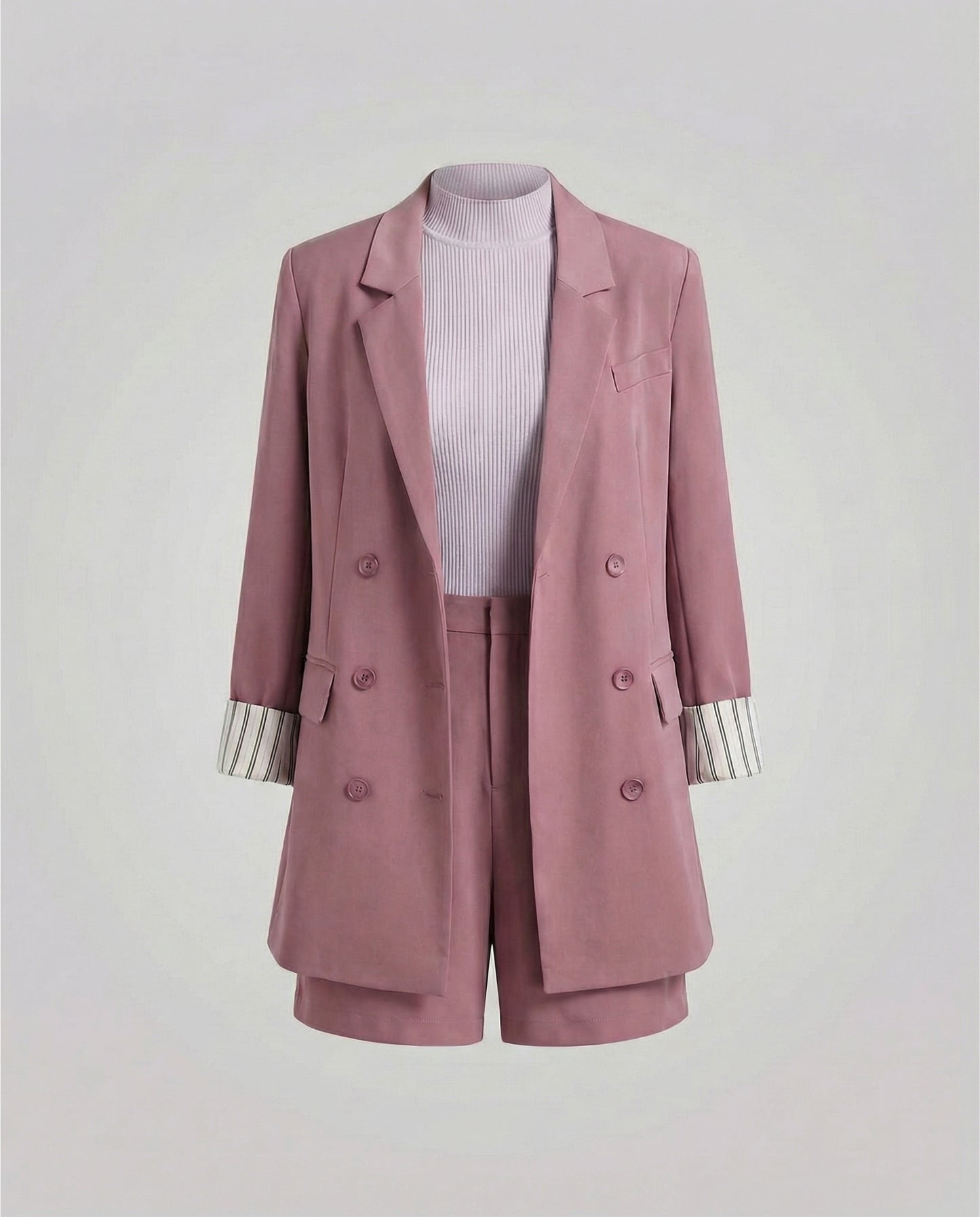 Pink blazer and shorts set on a light gray background
