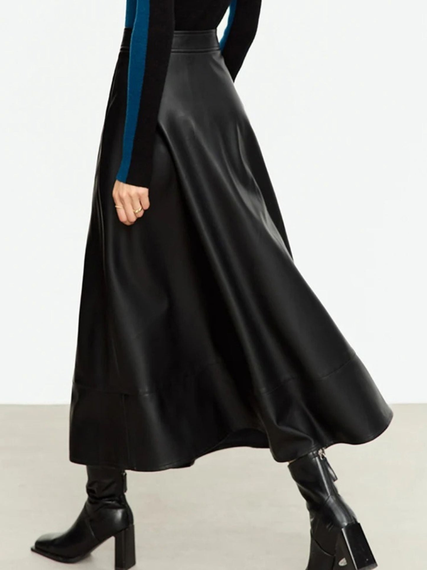 Back side view of black faux leather midi skirt showing smooth finish