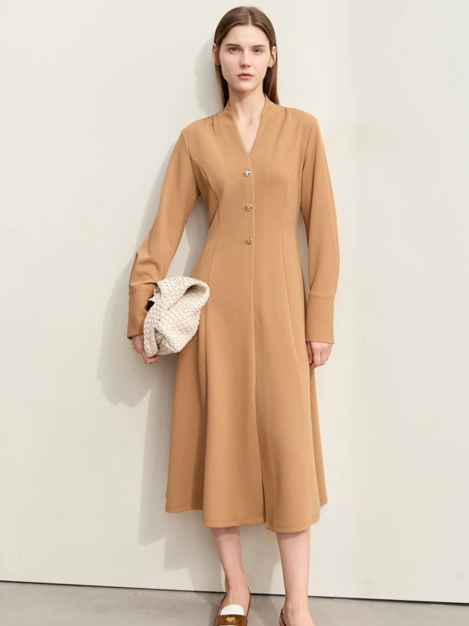 Front view of camel midi dress with button closure, long sleeves, and V-neckline