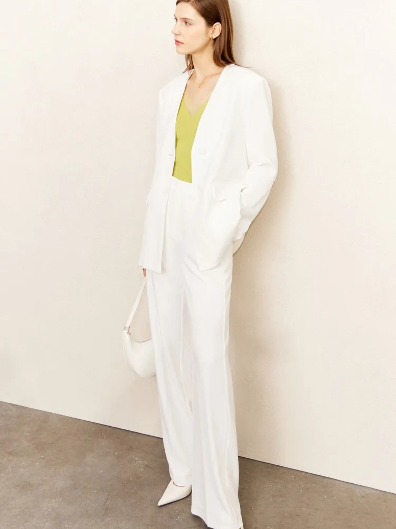 Woman in all-white belted pantsuit, paired with a yellow top and white heels