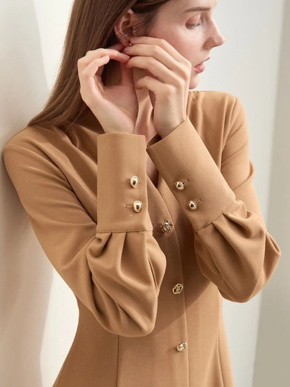 Close-up of camel midi dress neckline and front buttons, highlighting fabric texture and button design