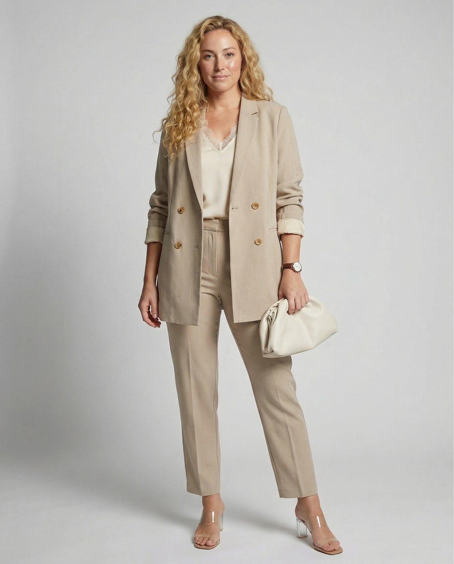 Woman wearing a beige suit with a white background