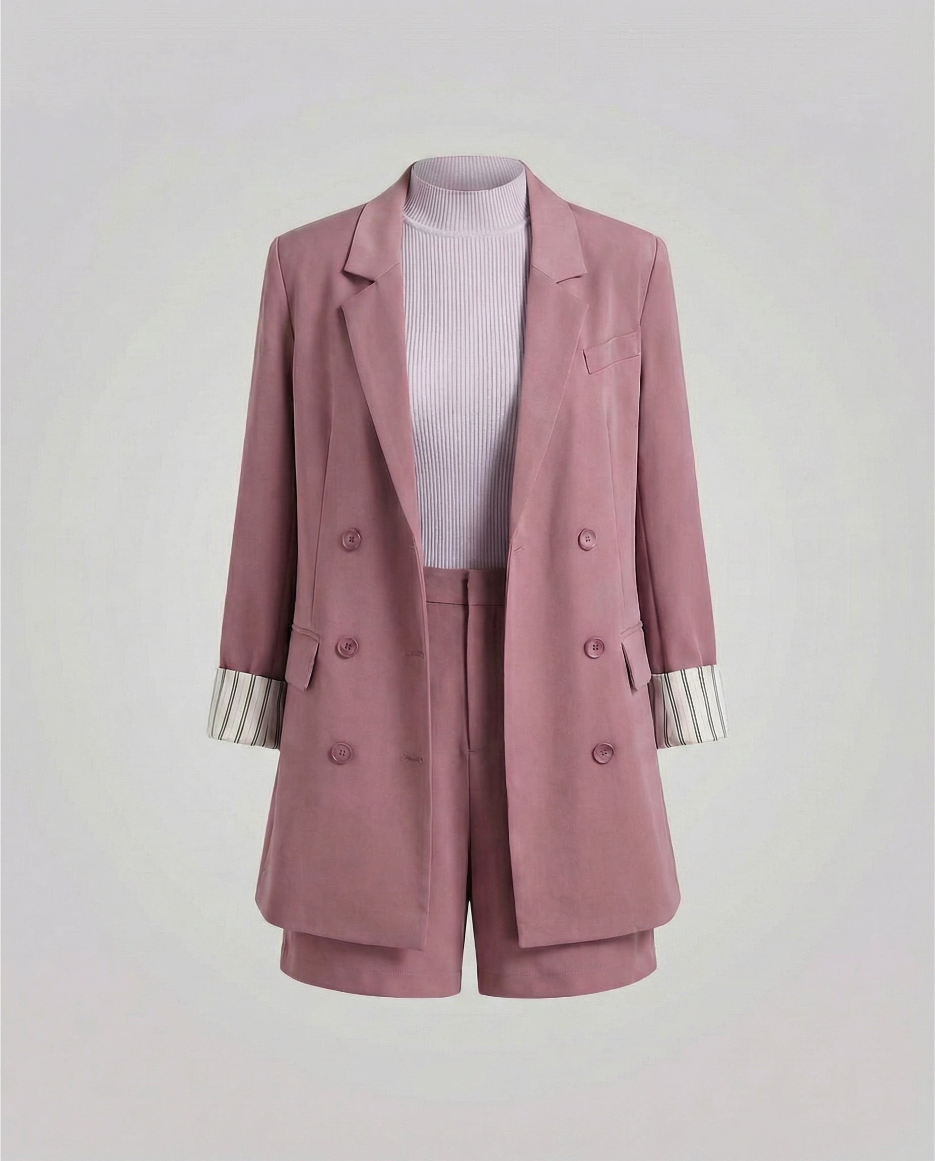 Pink blazer and shorts set on a light gray background