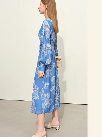 Side view of blue floral wrap midi dress with ruched front and long puff sleeves