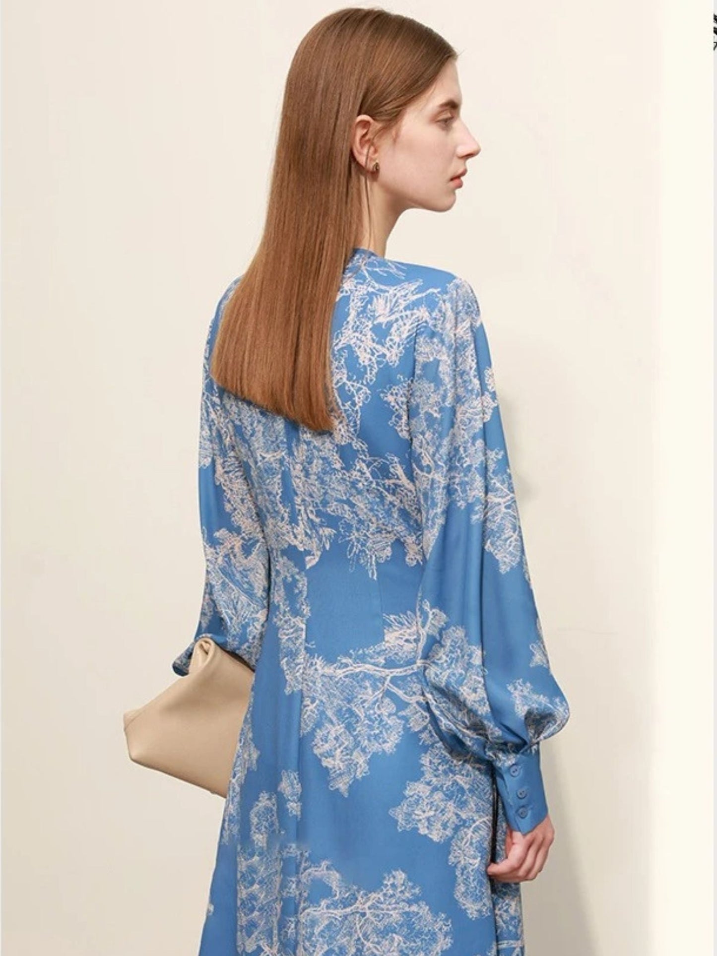 Back view of blue floral wrap midi dress showing loose fit and long sleeves