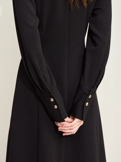 Close-up of black midi dress back with row of buttons and fitted sleeves