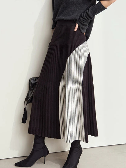 Back side view of black pleated midi skirt with light gray color-block panel