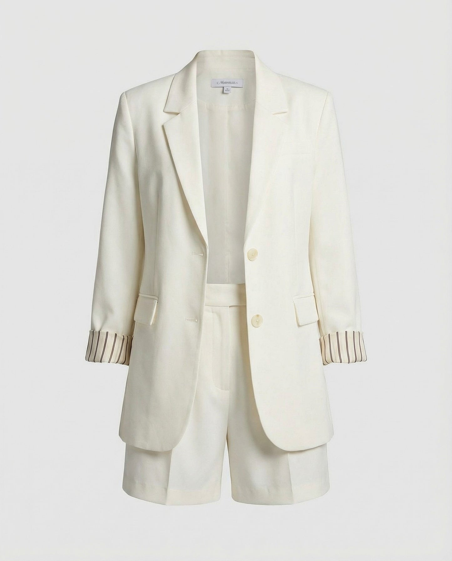 White blazer with striped cuffs on a light gray background