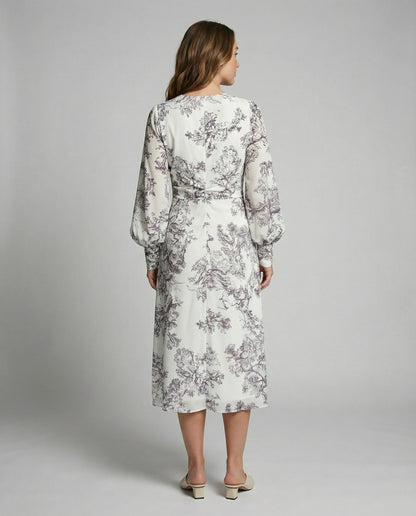 Woman wearing a floral dress on a plain background