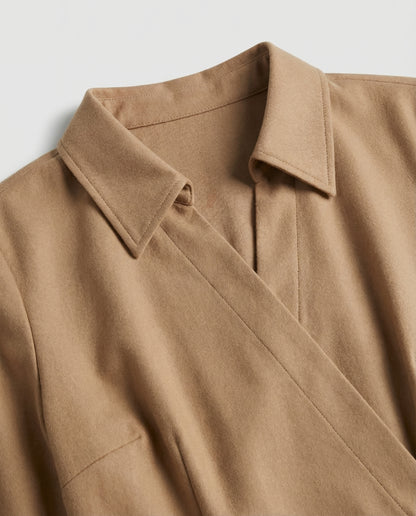 Close-up of a brown coat with a collar on a light gray background