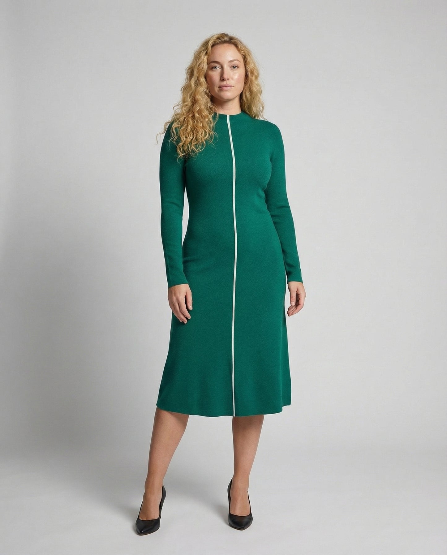 Woman wearing a green dress with a white zipper on a gray background