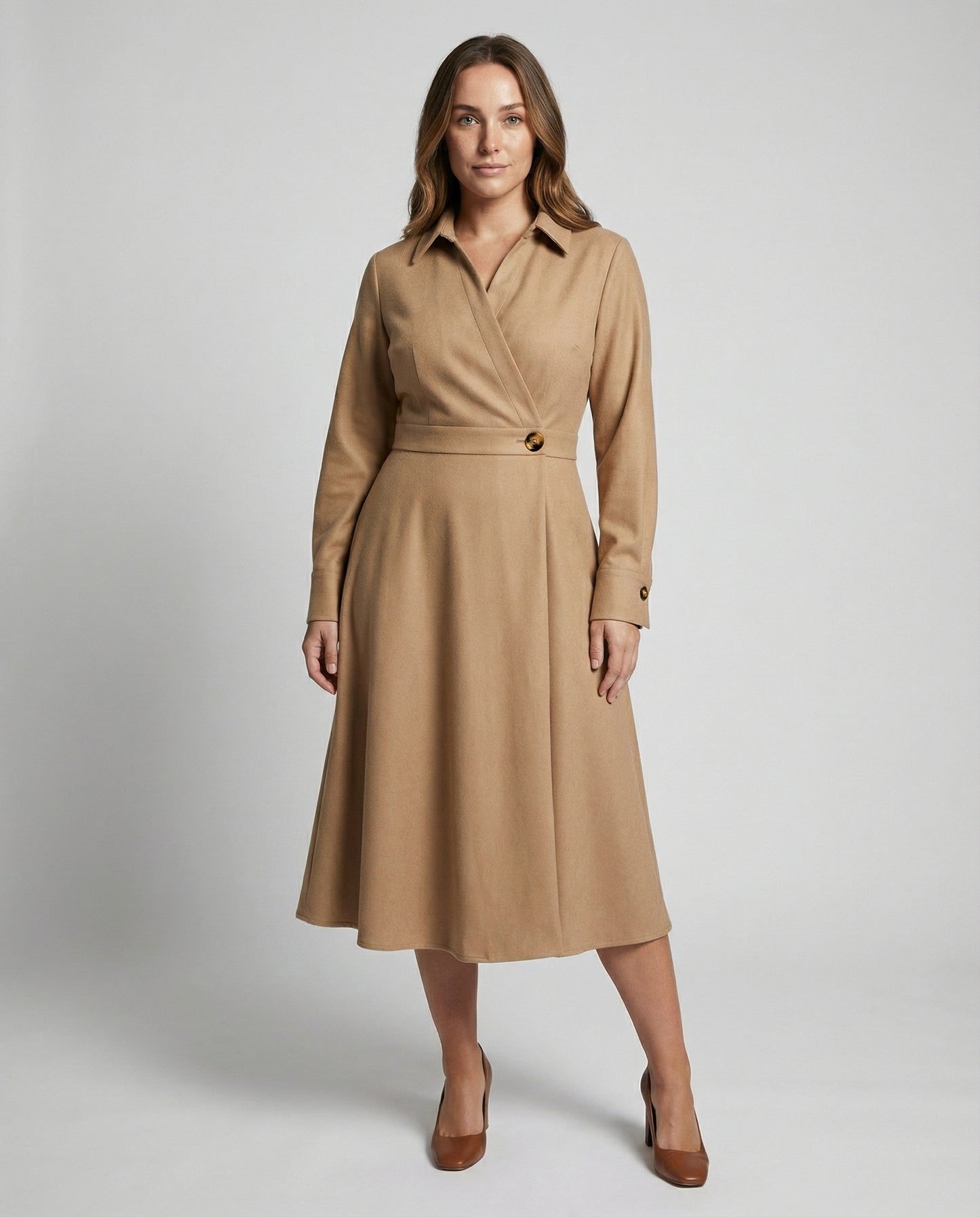 Woman wearing a beige trench coat on a plain background