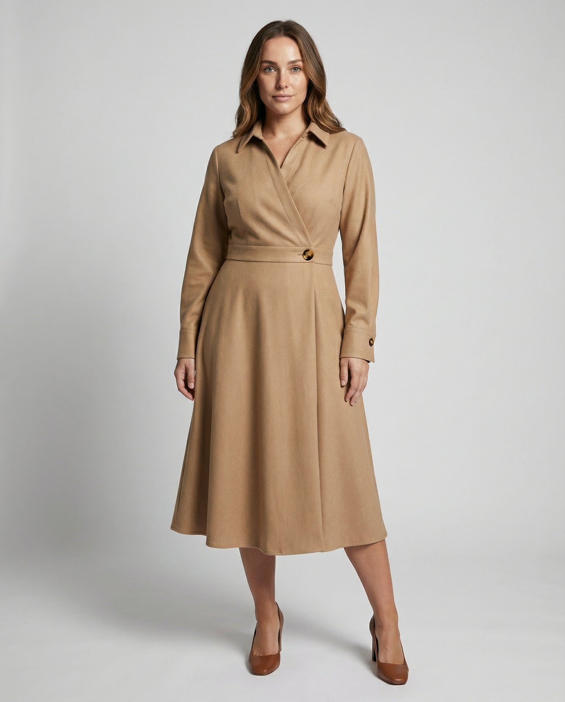 Woman wearing a beige trench coat on a plain background