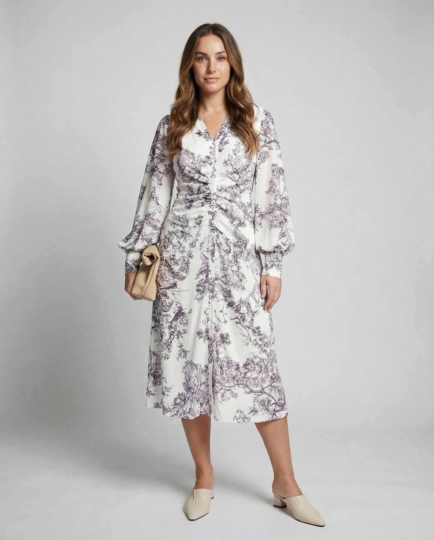 Woman wearing a floral dress with a plain background