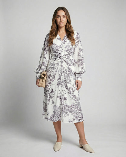 Woman wearing a floral dress with a plain background