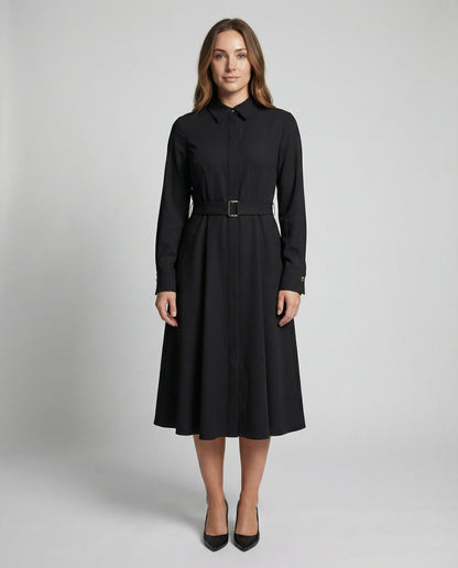 Woman wearing a black dress with a belt on a gray background